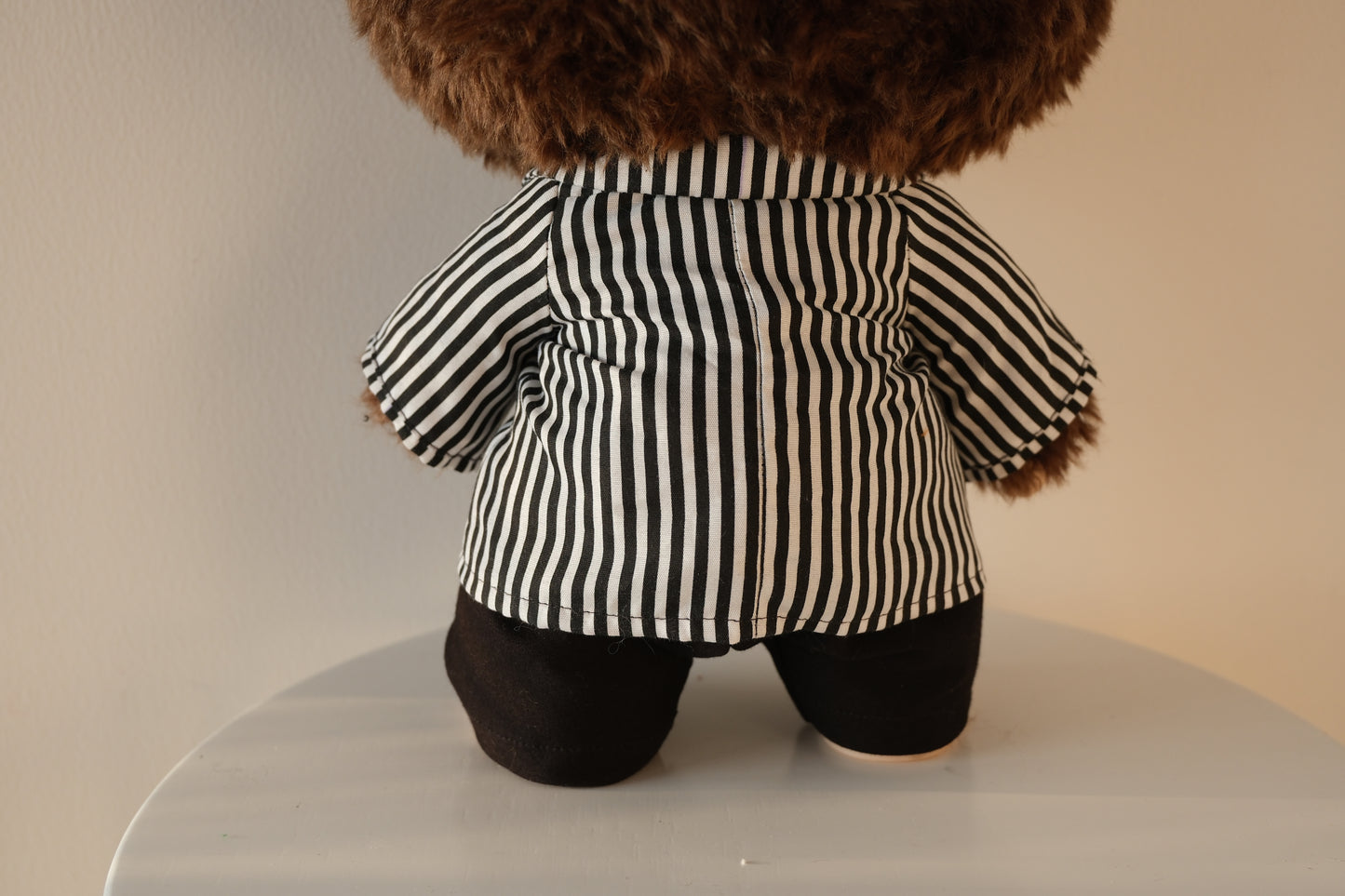 back view of 38cm Labubu wearing a black and white striped shirt and black tailored pants set