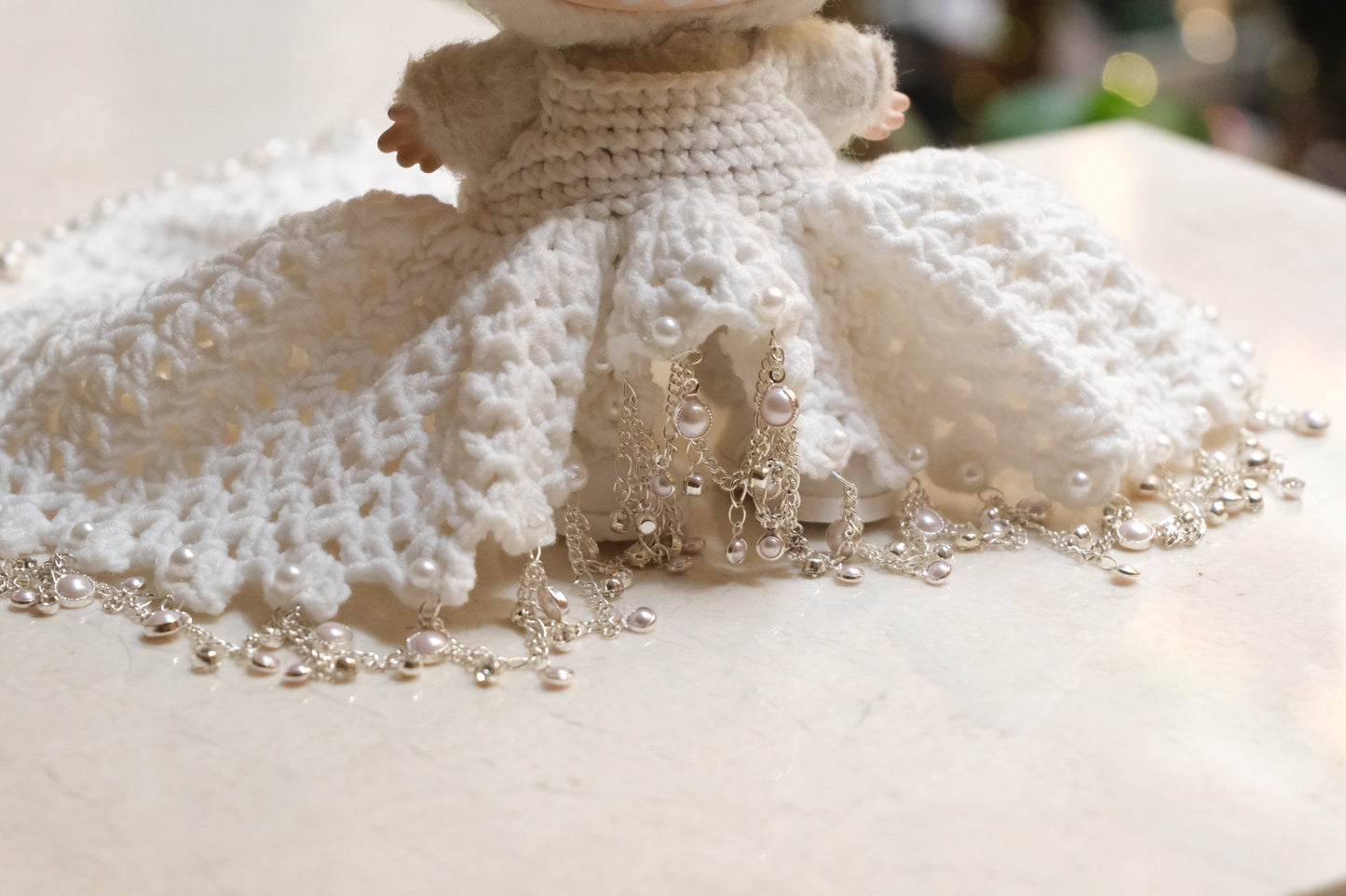 Close-up on The Monsters figure, highlighting the intricate lace design on the bodice of the white dress