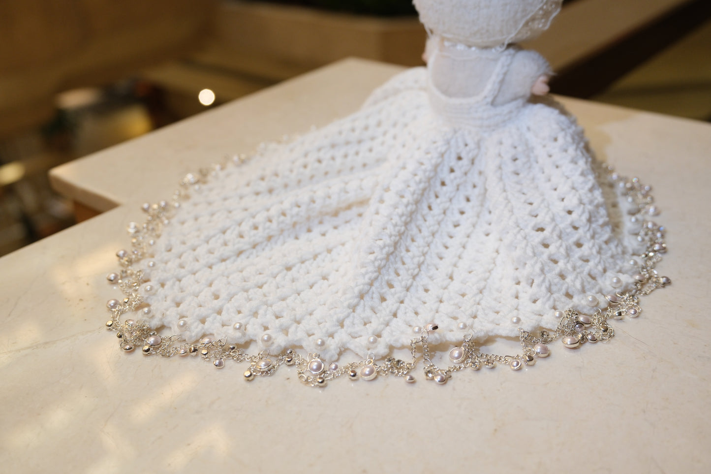 Close-up on The Monsters figure, highlighting the intricate lace design on the bodice of the white dress