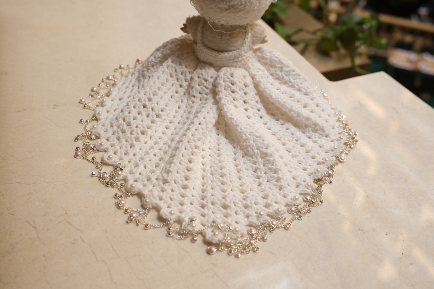 Close-up on The Monsters figure, highlighting the intricate lace design on the bodice of the white dress