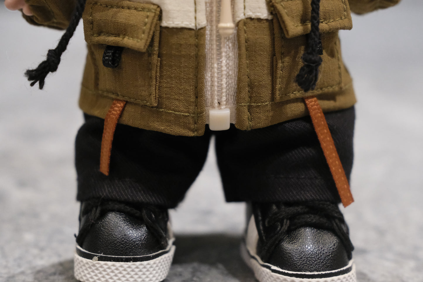 Detailed shot of the Labubu figure's red parka, zipper, and drawstrings.