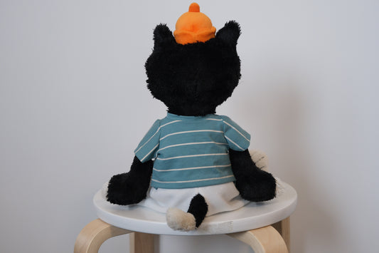 back view of jellycat jack wearing a striped shirt a white pants