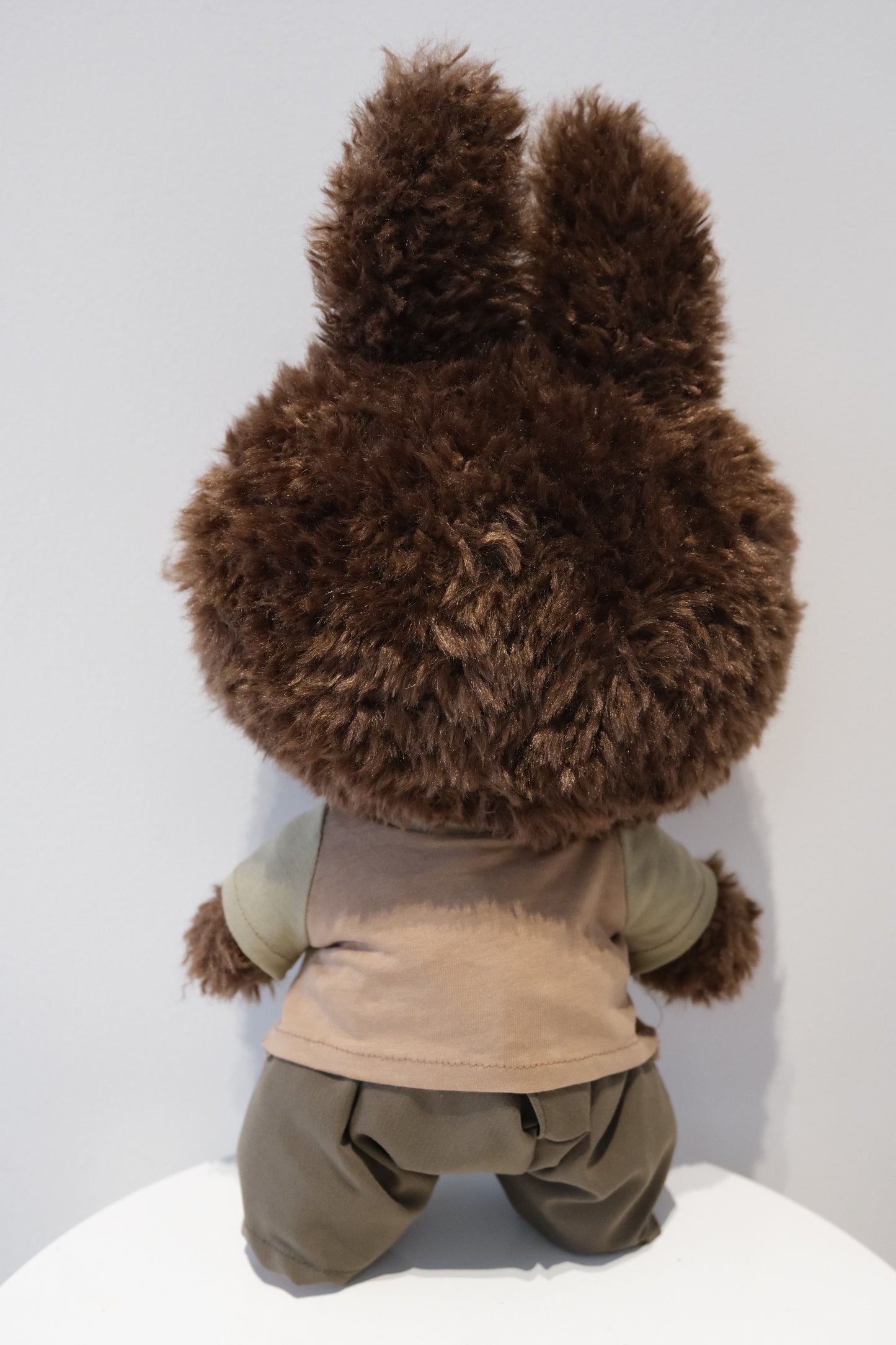 back view Labubu figure wearing a 2-piece reconstructed utility outfit from the Let's Checkmate series, featuring multi-shaded grey paneled pants and a graphic streetwear T-shirt.