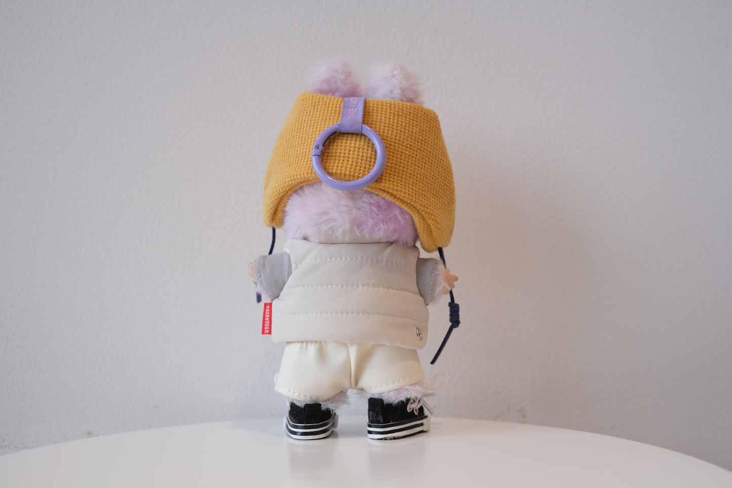 back view of the Labubu figure in the sporty streetwear set, highlighting the jogger pants and sneakers.