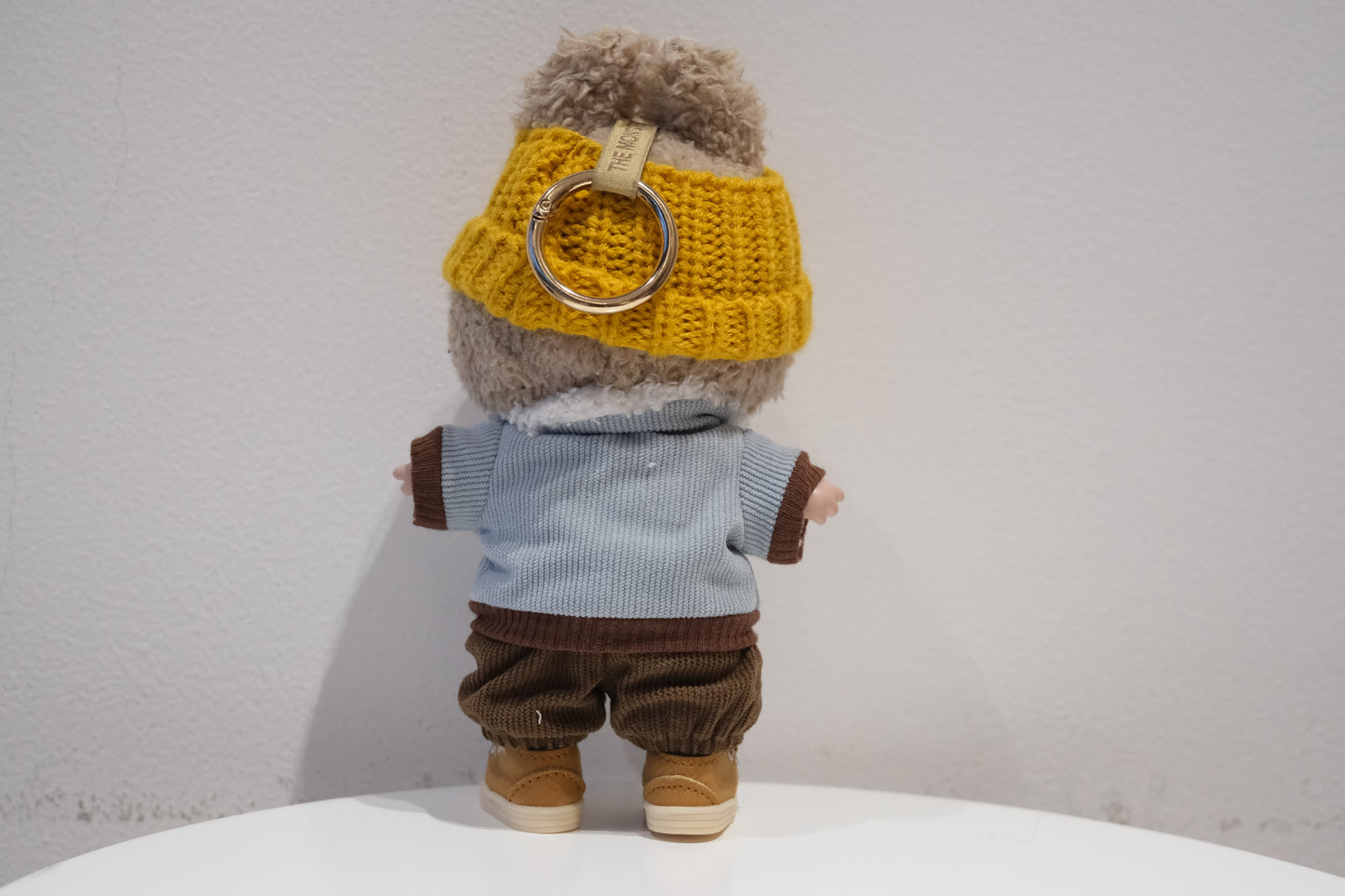 back view of Labubu figure wearing a 4-piece urban streetwear outfit with a blue puffer jacket, beanie, pants, and sneakers