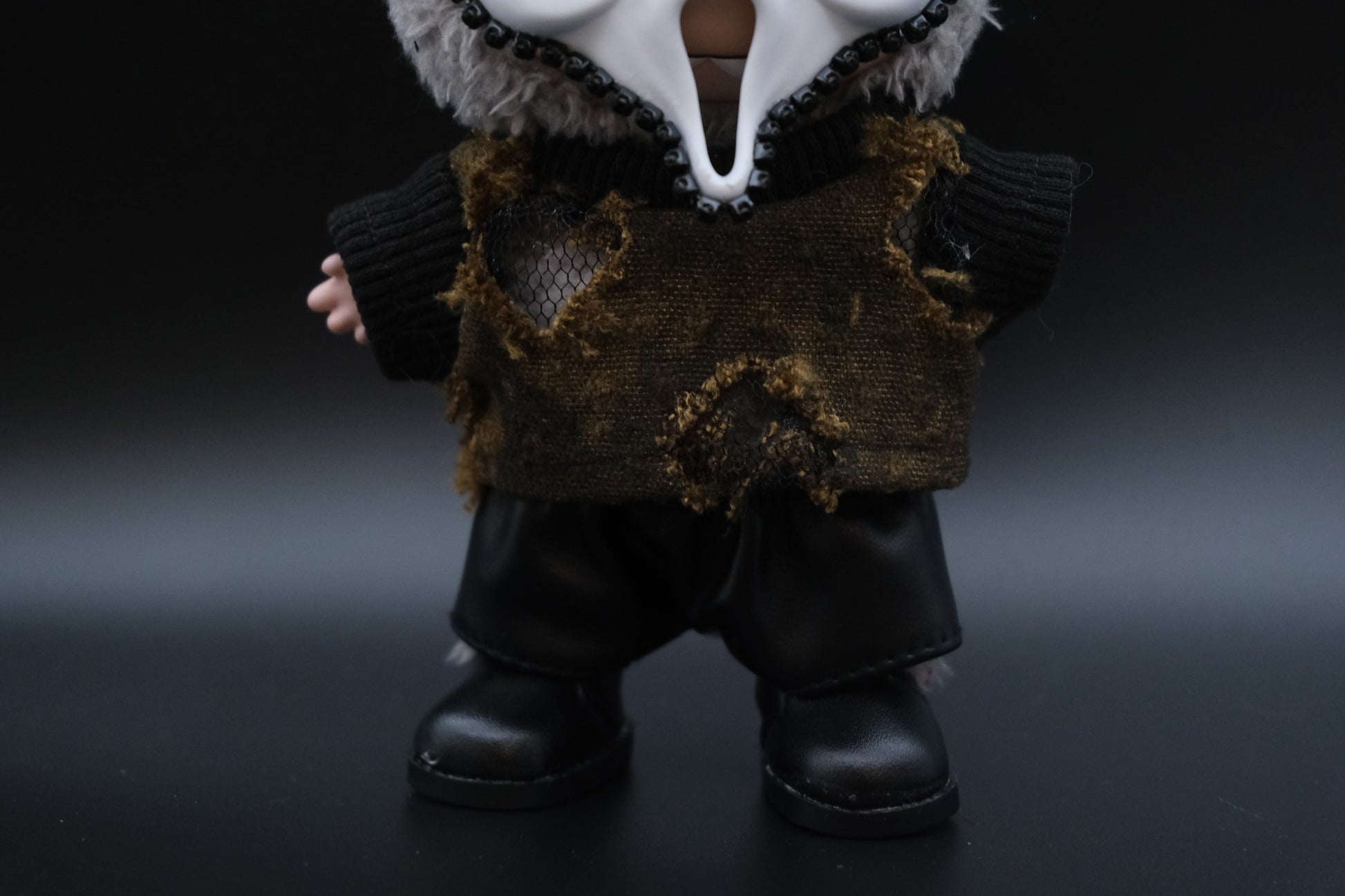 A Labubu figure wearing a 4-piece spooky minimalist outfit, including a wateland T-shirt and a skull mask