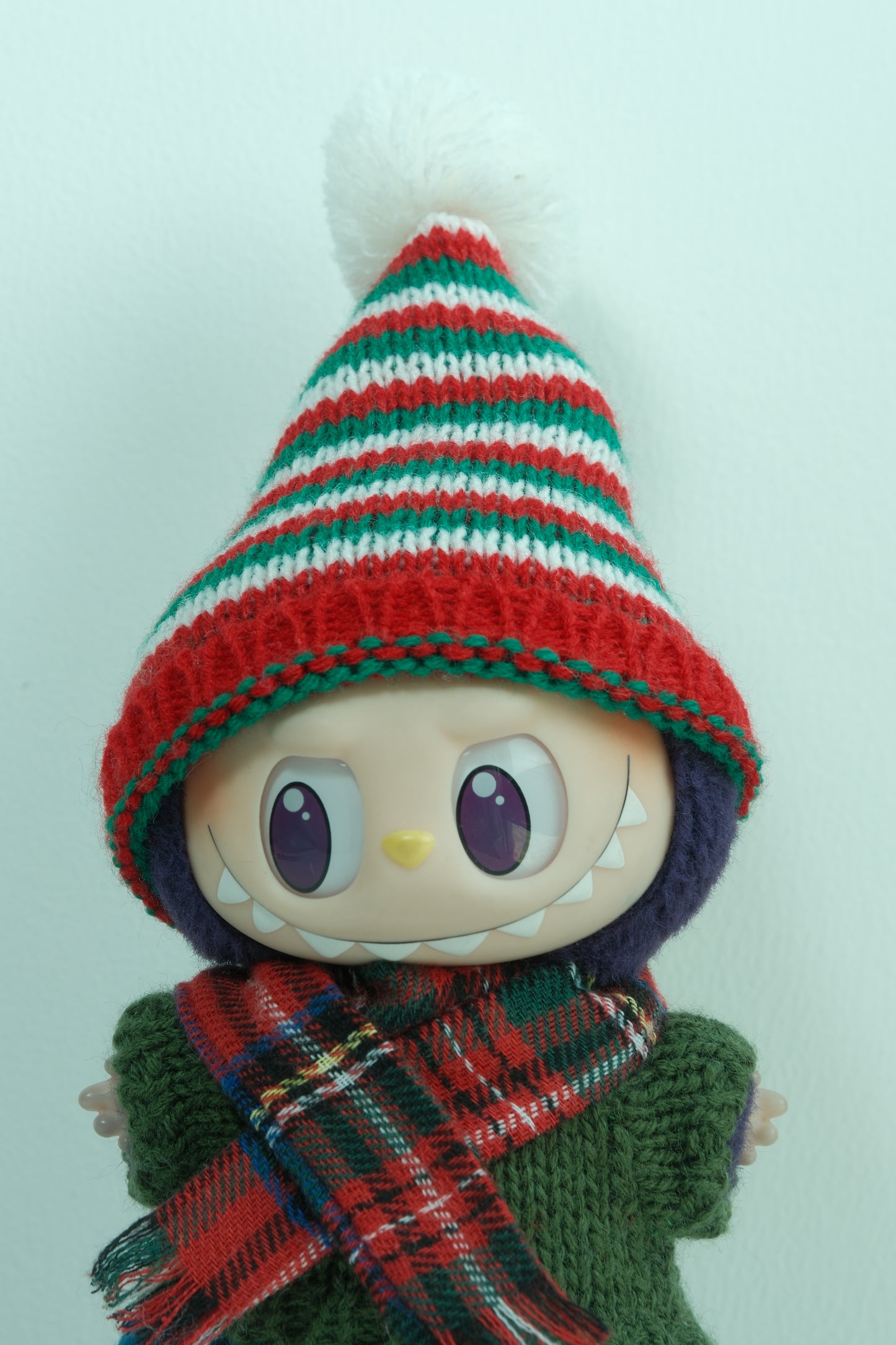 labubu with a striped hat and plaid scarf