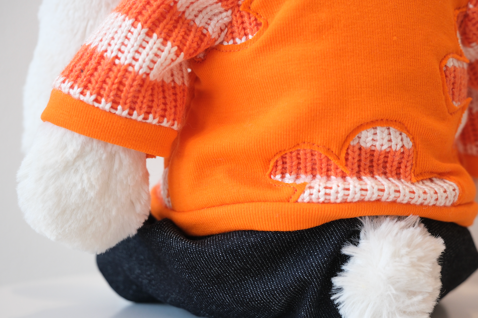 Close-up of the miniature soft fabric crewneck sweatshirt detail on a Jellycat Bunny doll.