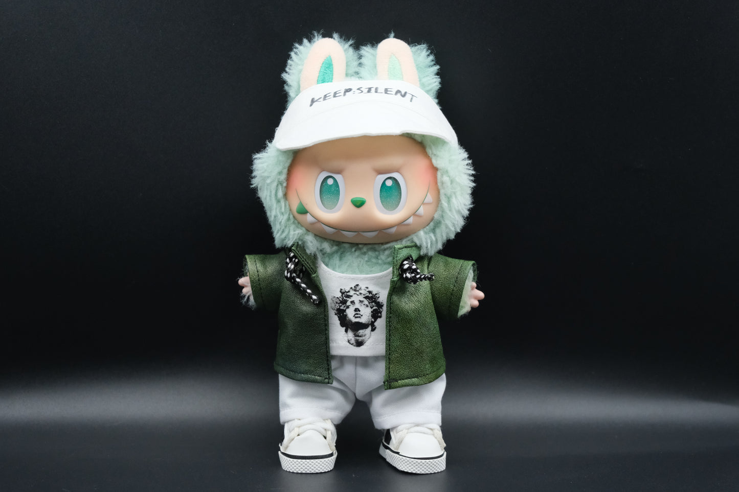 A Labubu wear a green leather jacket, white t-shirt, white pants, white shoes and cap