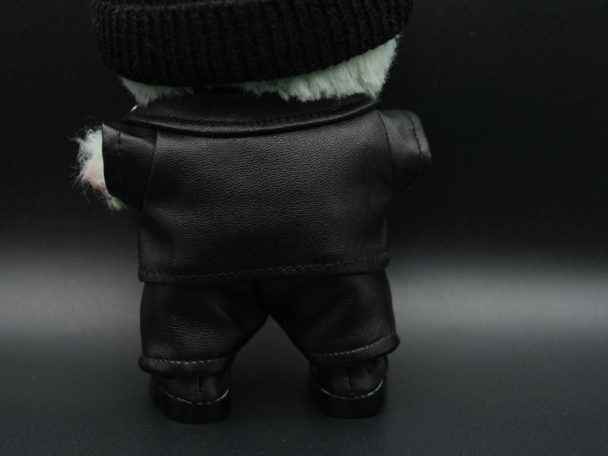 back view of A Labubu figure wearing a black leather jacket, a white graphic t-shirt underneath, black leather pants, and black sneakers.
