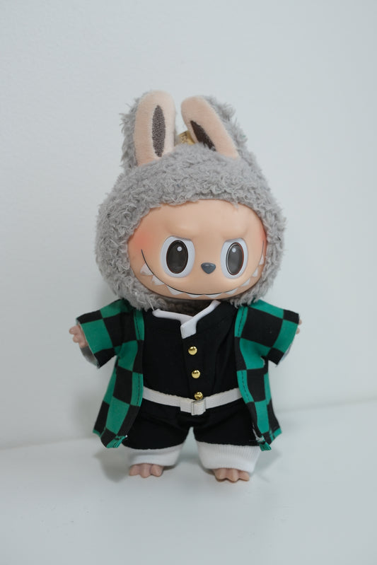 Labubu figures wearing three different Demon Slayer inspired cosplay outfits: Tanjiro