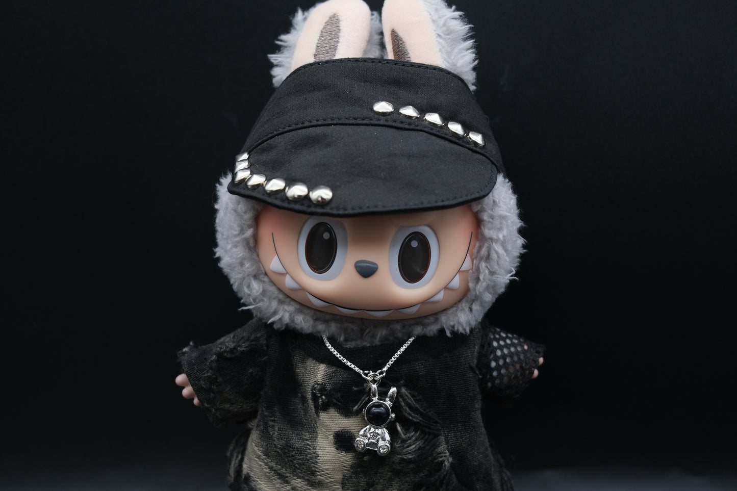 Labubu designer toy figure showcasing a modern streetwear look, featuring a punk hat , a black mixed dyeing distressed T-shirt,