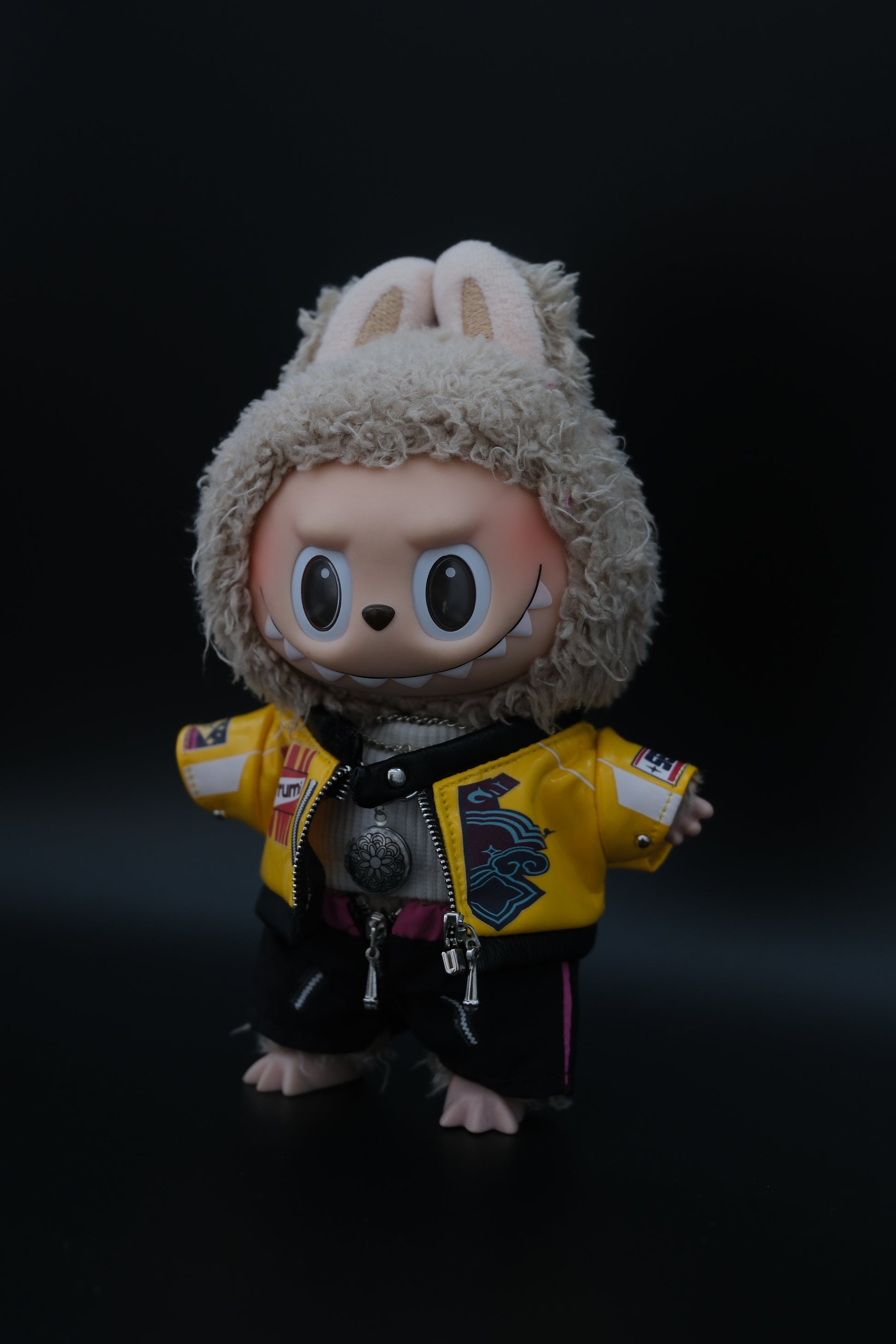 Closeup of the kpop demon hunter outfit, including jacket, pants, crop-fit turtleneck and labubu necklace