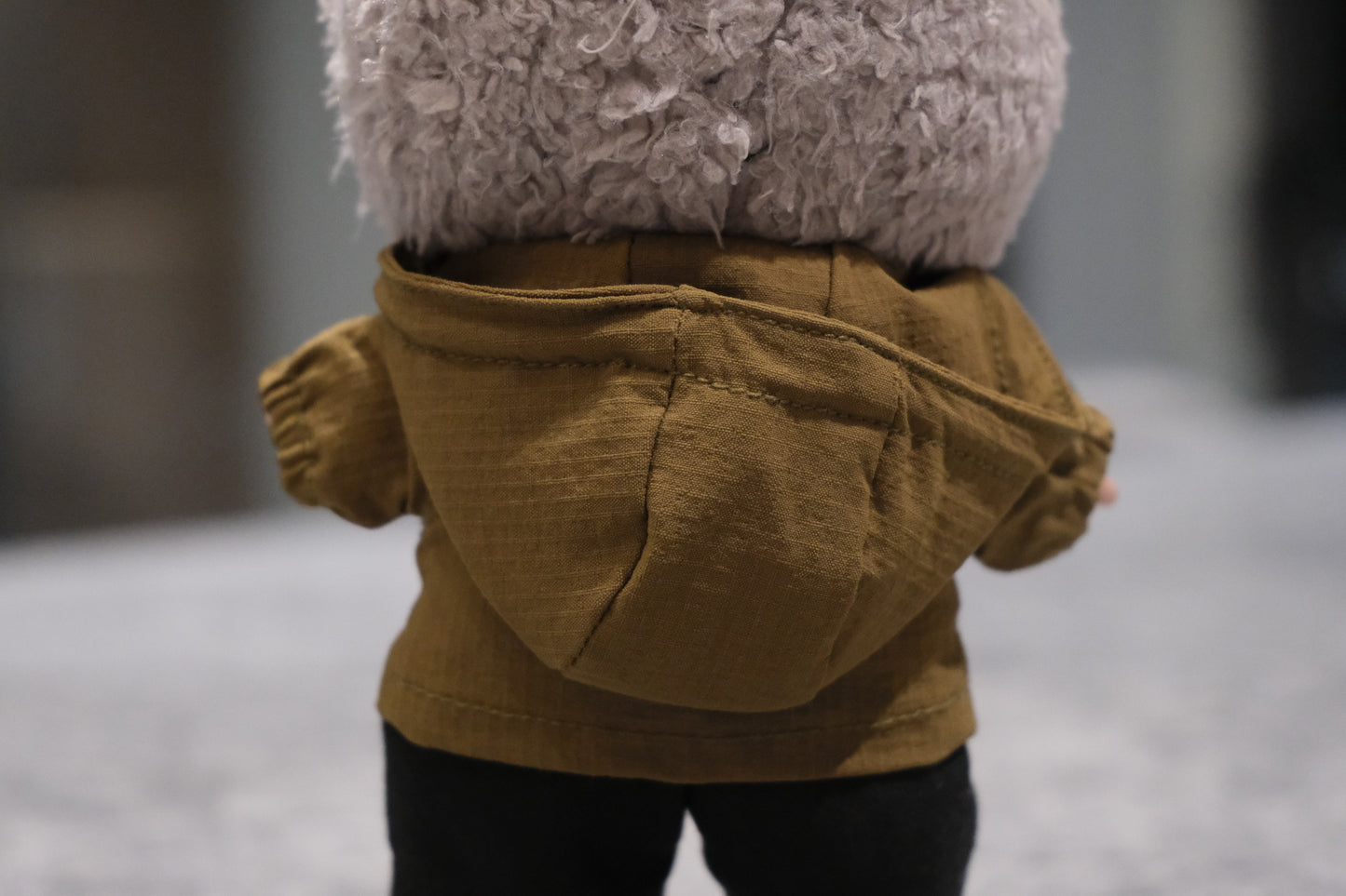 back view of labubu wearing hiking set