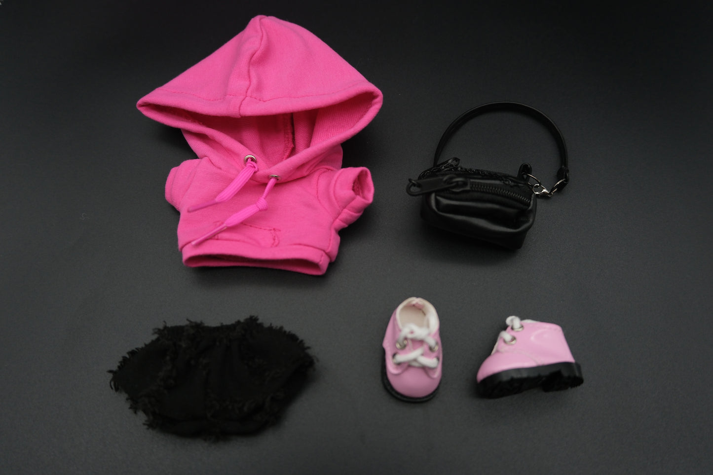 Labubu's a pink hoodie, black pants, crossbody bag and pink sneakers.