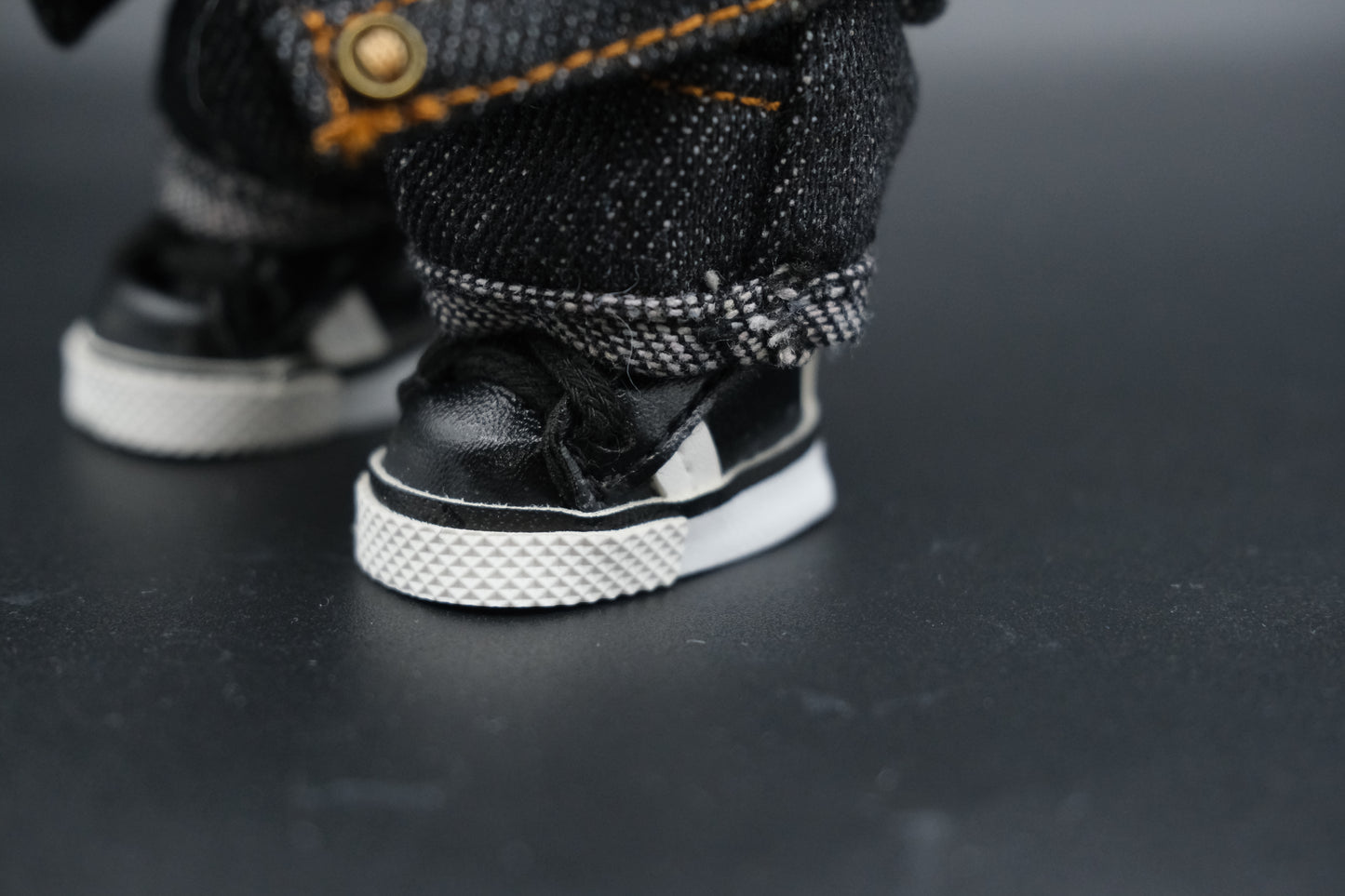 Close-up of black shoes from the Labubu black denim jacket outfit