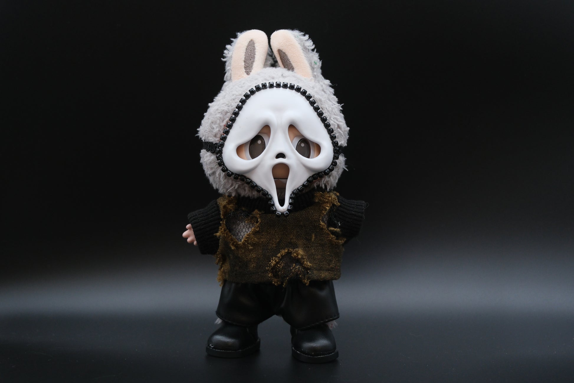 A Labubu figure wearing a 4-piece spooky minimalist outfit, including a wasteland T-shirt and a skull mask