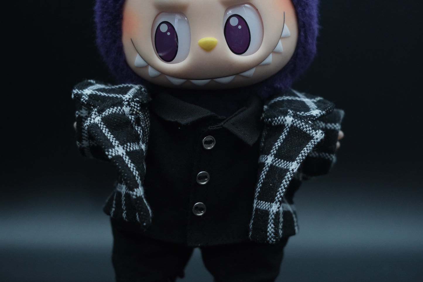 Close-up of a labubu wearing stylish plaid jacket from the streetwear outfit set.