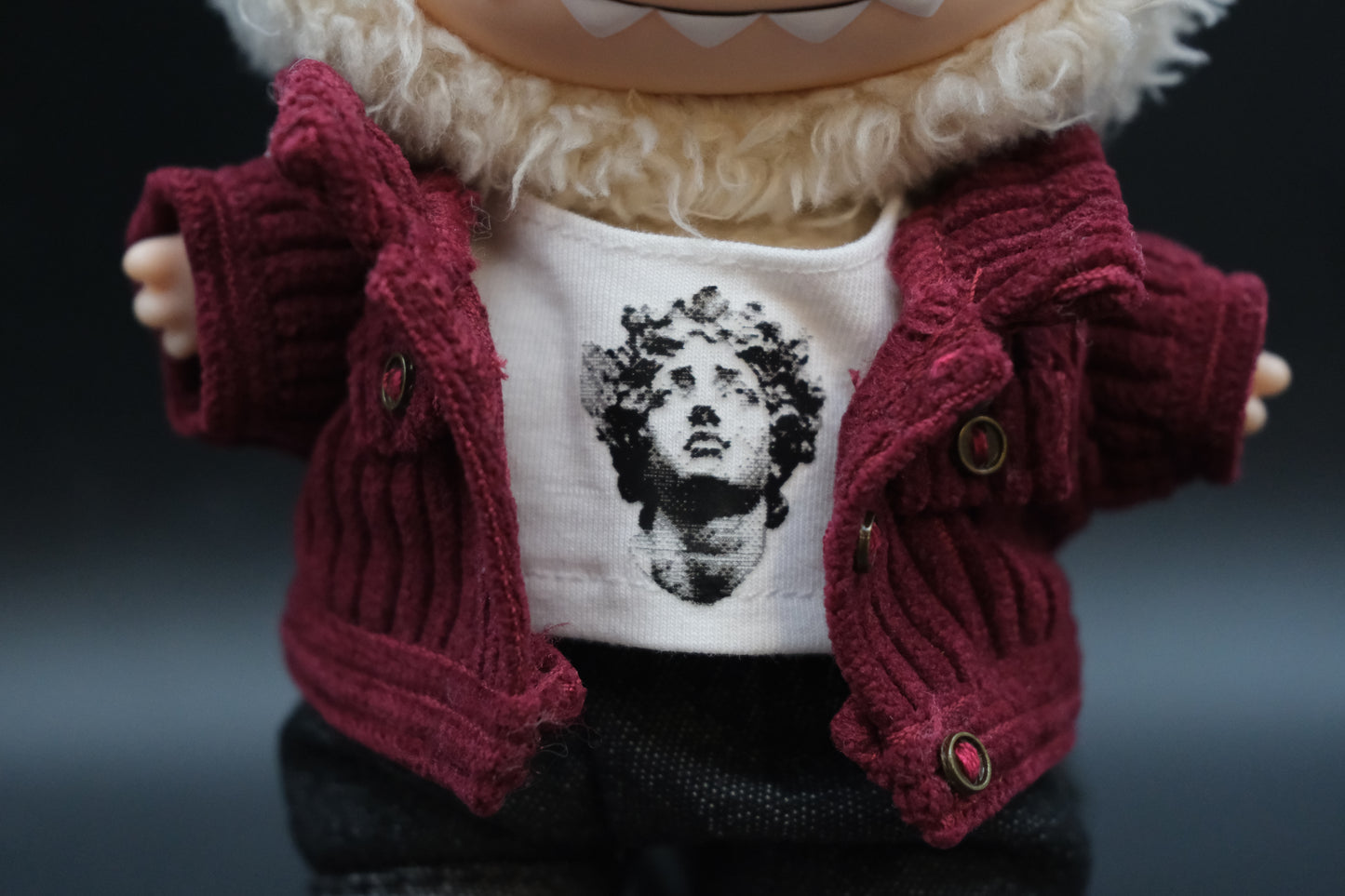 Close-up of a Labubu's t-shirt and jacket
