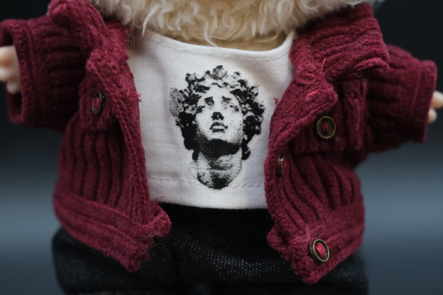 Close-up of a Labubu's t-shirt and jacket