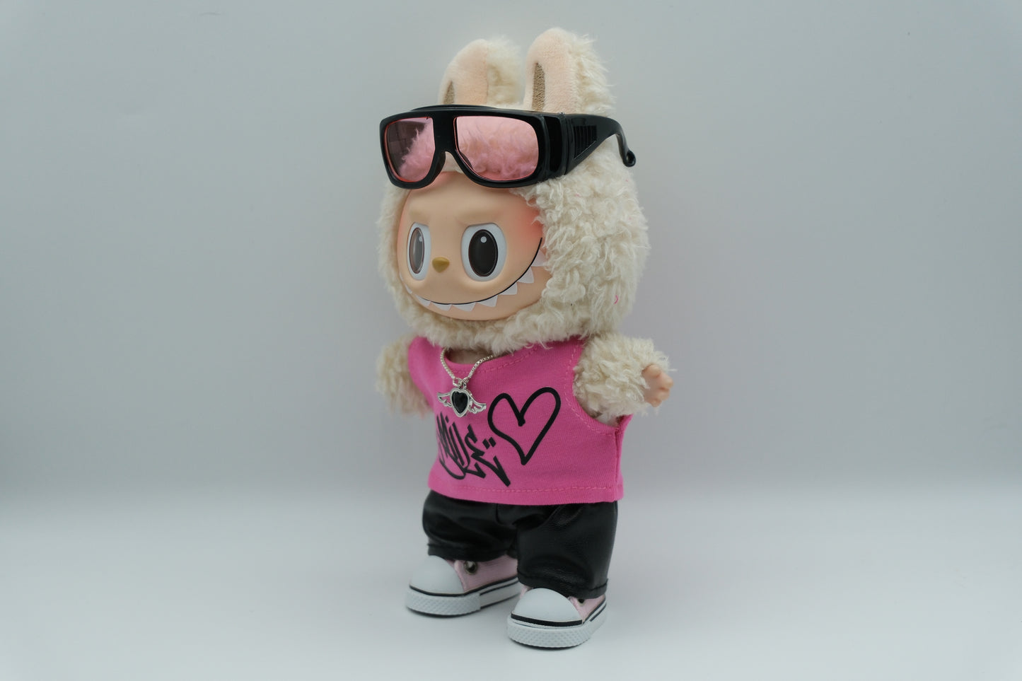 labubu wear a sunglasses, pink vest and black leather pants and pink shoes