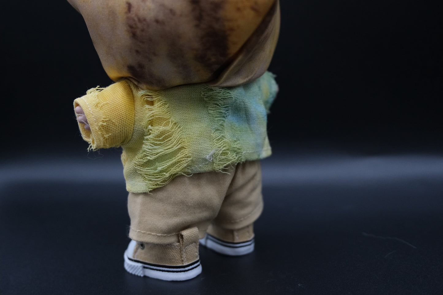 LABUBU plush doll wearing a distressed tie-dye hoodie, khaki pants