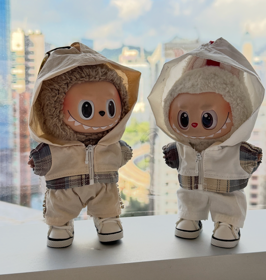 A trendy Labubu designer toy figure wearing a minimalist white zip-up hoodie with a contrasting white zipper, white pants, and stylish white high-top sneakers with black accents.