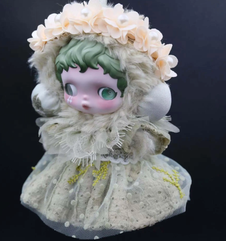 A Skullpanda figure wearing a custom-made, mint-colored feather dress and a fluffy cap with lace trim