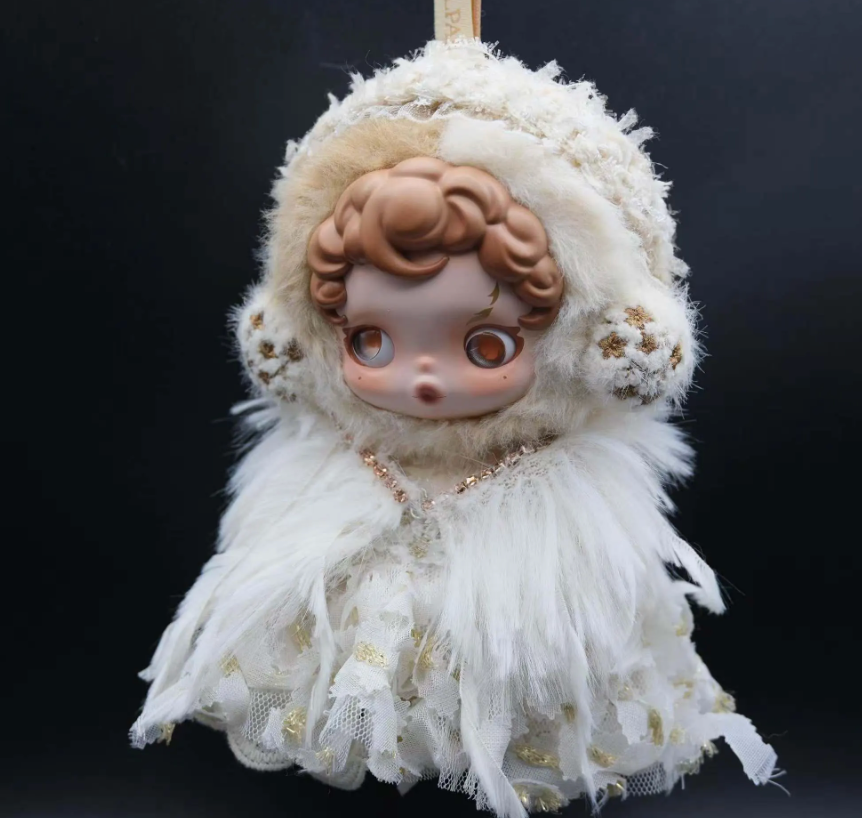 Full-body shot of a Skullpanda figure wearing a custom-made, white feather dress and a fluffy cap with lace trim.