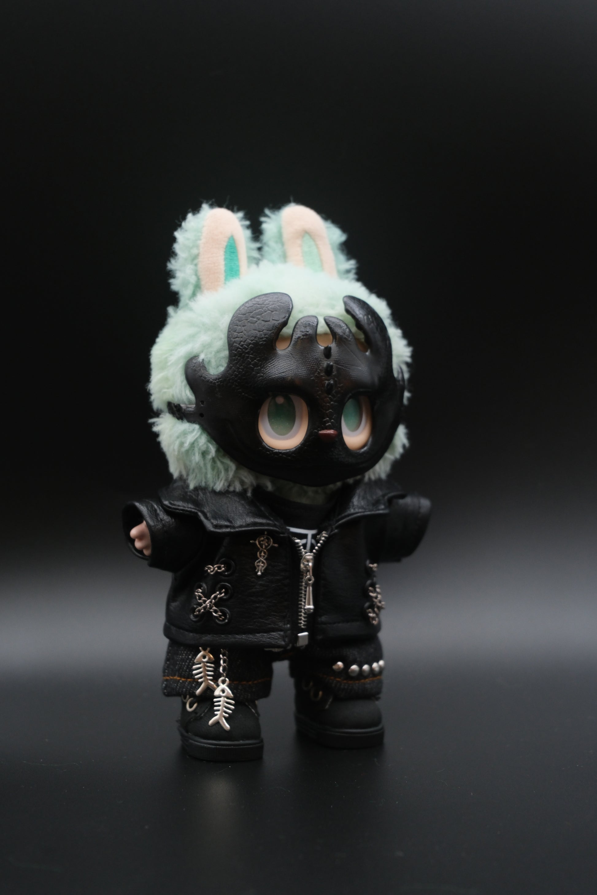 A Labubu figure wearing a 5-piece monster streetwear outfit, including a black leather jacket, jeans, and a scary mask.