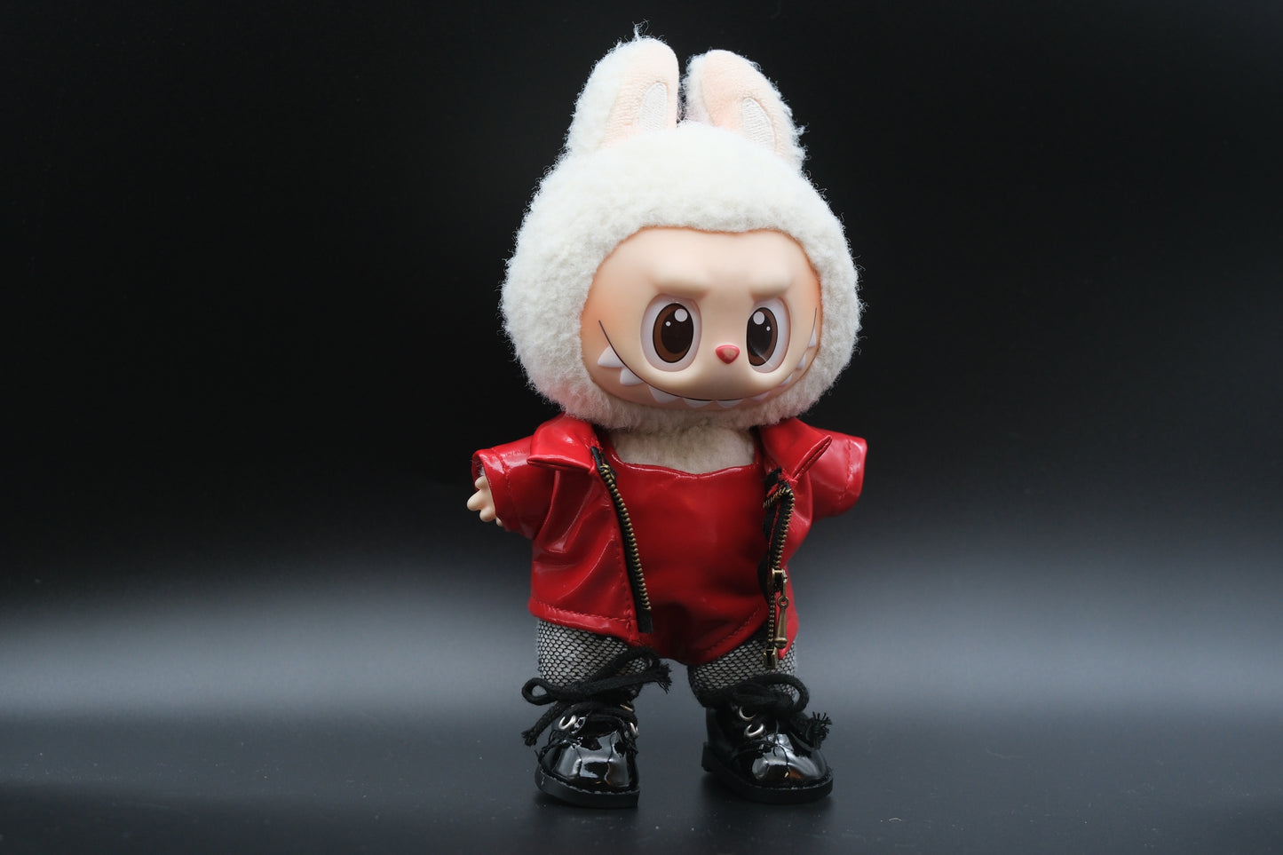LABUBU plush doll wearing a handmade leather jacket, vest, and fishnet stockings, inspired by Blackpink's Lisa