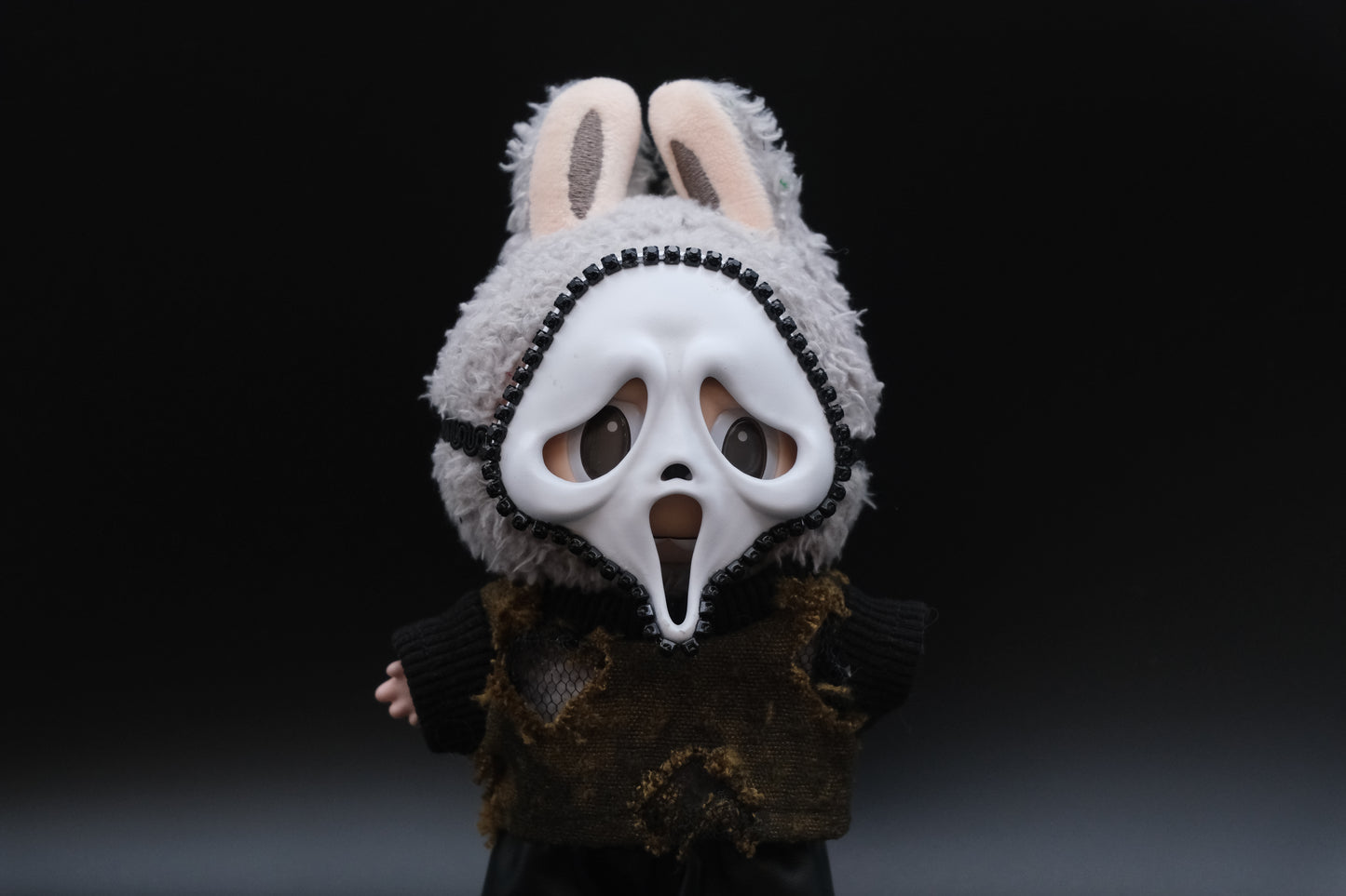 A Labubu figure wearing a 4-piece spooky minimalist outfit, including a wasteland T-shirt and a skull mask