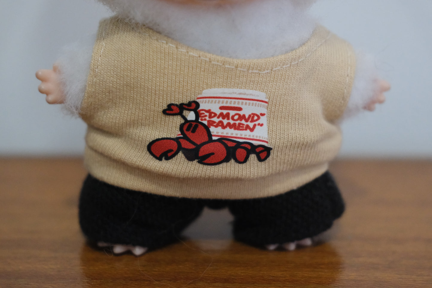 A close-up shot of The Monsters figure's lobster and "REDMOND RAMEN" logo.