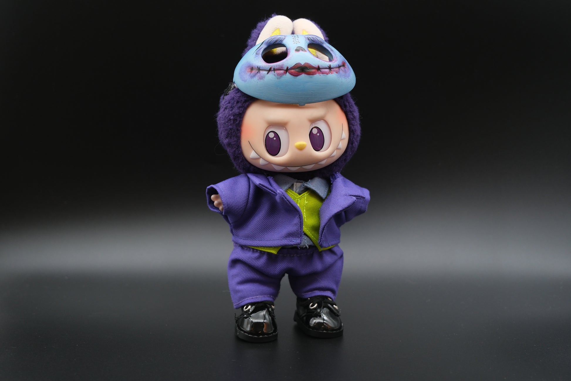 A Labubu figure wearing a 6-piece Halloween Joker costume, including a purple suit, green vest, shoes, and signature mask