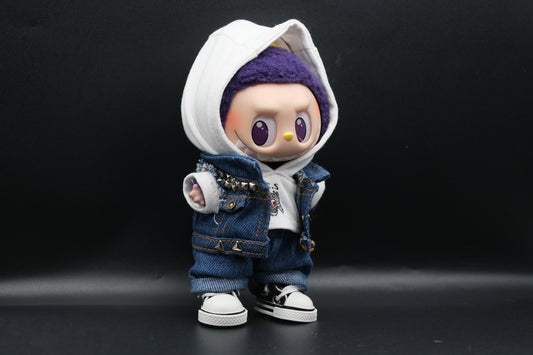 A Labubu designer toy figure showcasing a streetwear look with a white hoodie, a denim jacket, denim jeans and black sneakers.