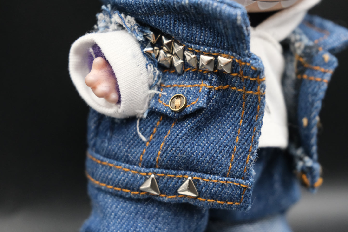 a close up of labubu denim jacket and white hoodie