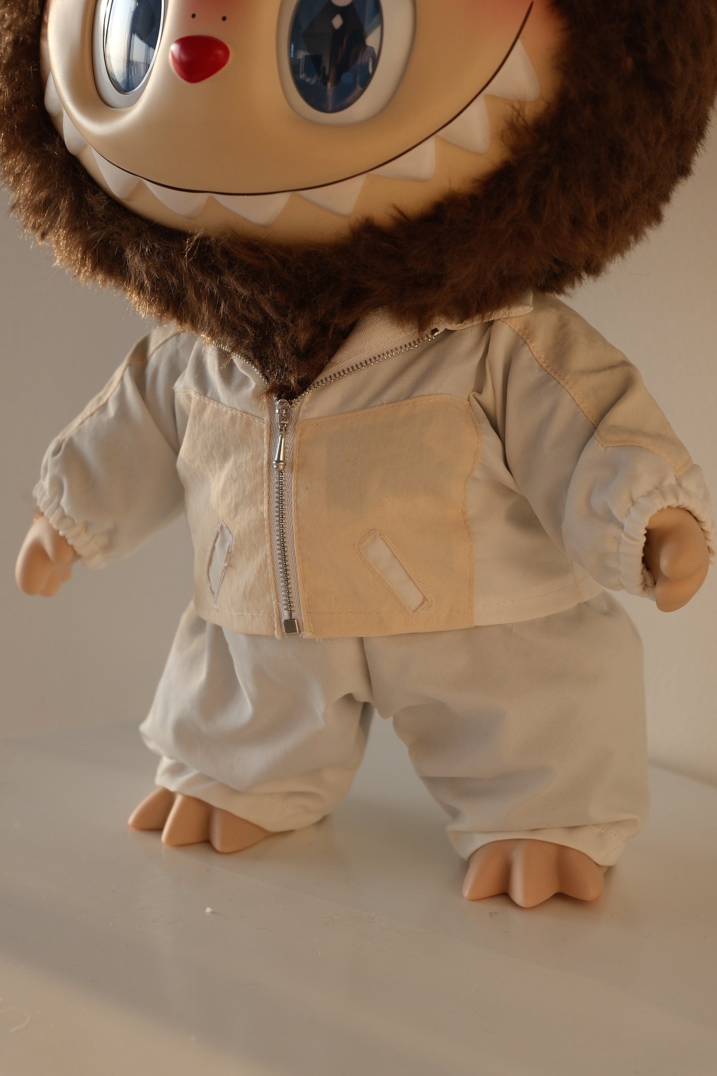 Macro close-up of the blue sequins on the 38cm Labubu jacket, showing the light-reflective texture