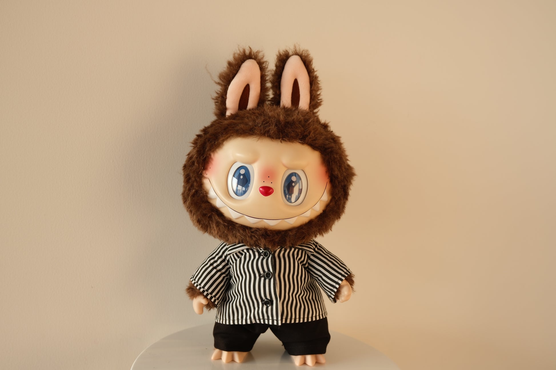 Front view of 38cm Labubu wearing a black and white striped shirt and black tailored pants set