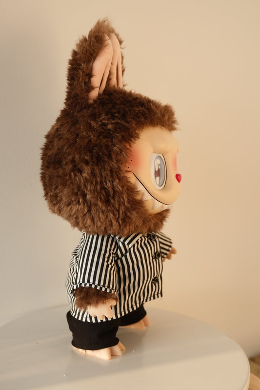 side view of 38cm Labubu wearing a black and white striped shirt and black tailored pants set