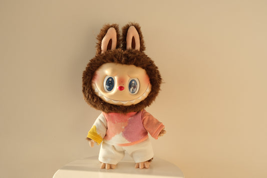 A 38cm Labubu figure wearing a vibrant gummy-colored neon hoodie and crisp white pants streetwear set