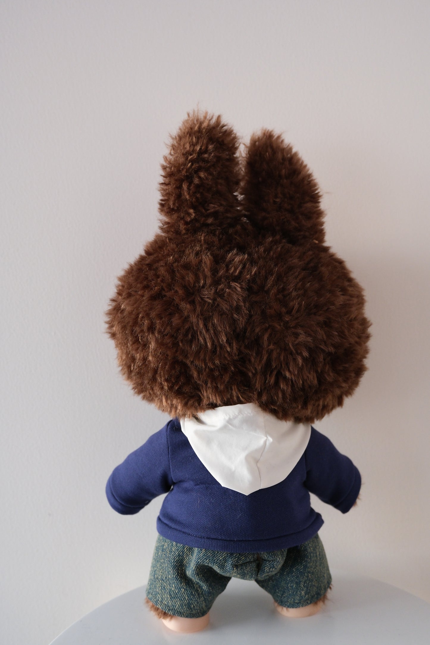 Back view of 38cm Labubu in the streetwear set, highlighting the oversized hood and wide-leg denim silhouette