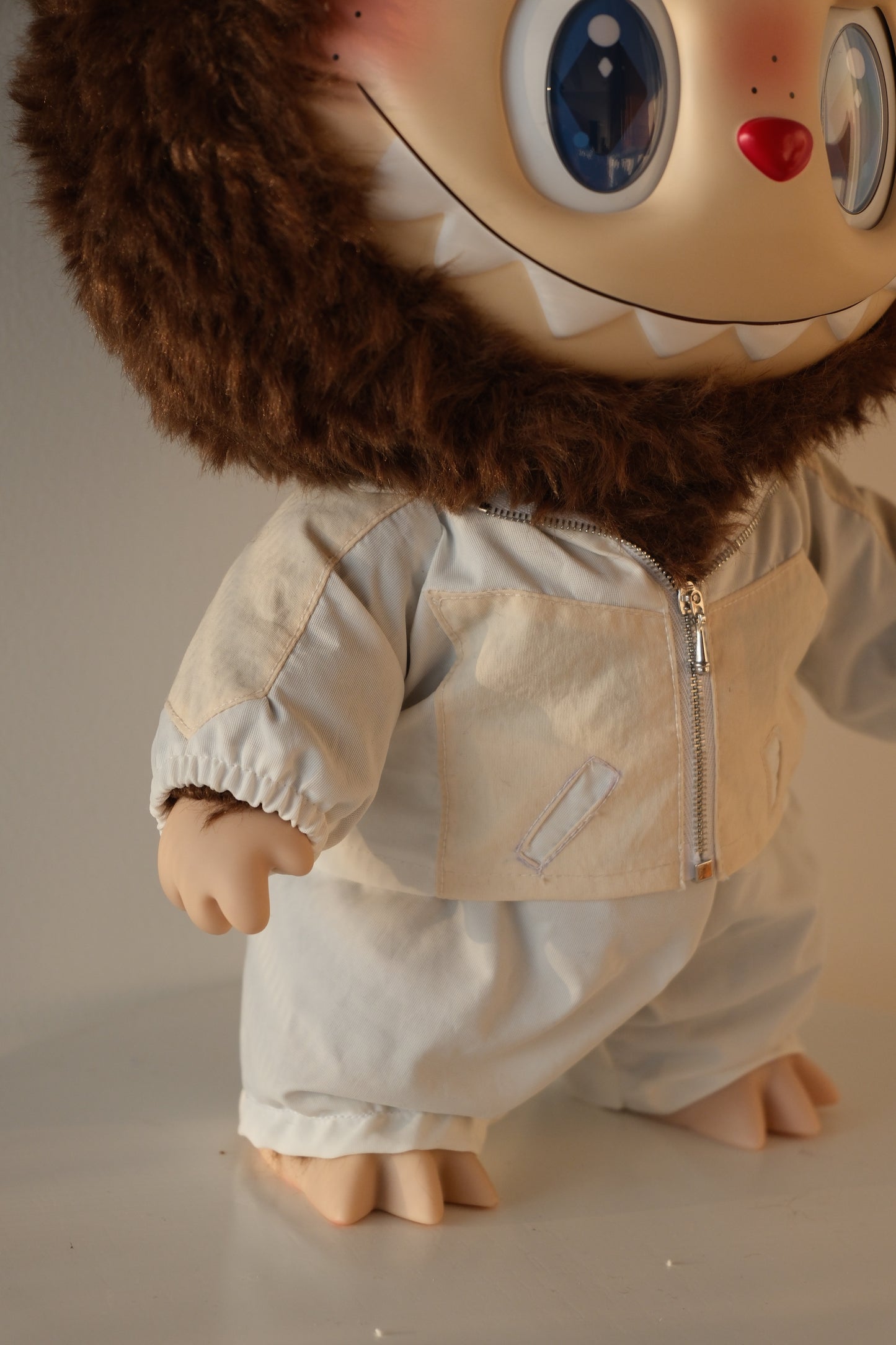 Macro close-up of the blue sequins on the 38cm Labubu jacket, showing the light-reflective texture.