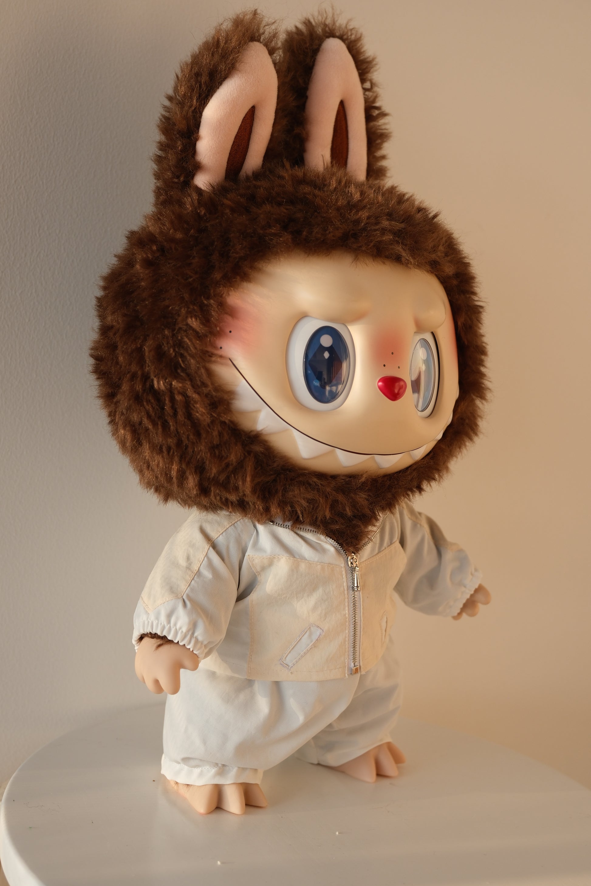 side view of 38cm Labubu in the Bejeweled set, highlighting the fit of the sequin bomber jacket