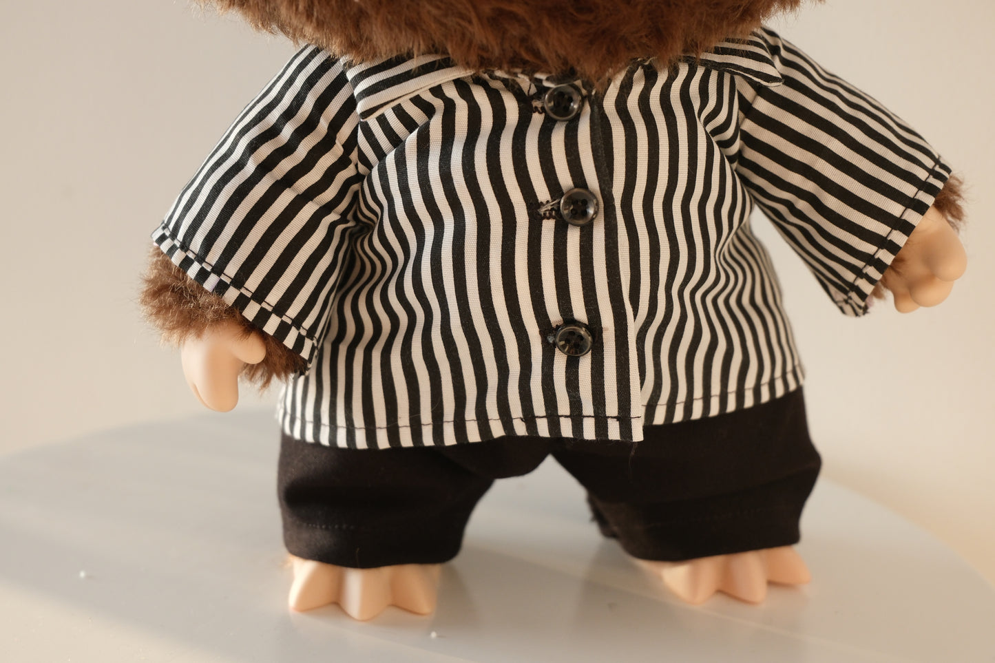Close-up of the black and white striped pattern and collar detail on the 38cm Labubu Checkmate shirt