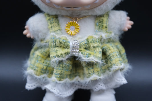a close -up of Labubu were green Twee Dress Set including hat, green dress, white shoes and flower necklace