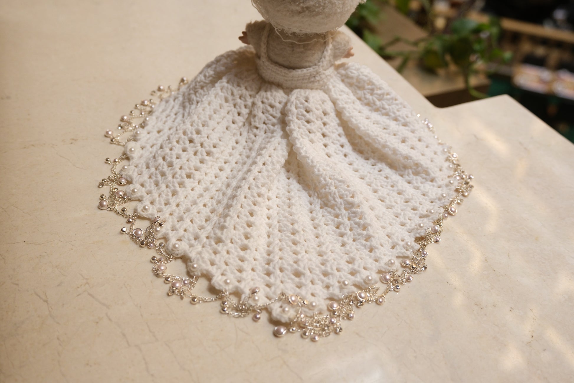Close-up on The Monsters figure, highlighting the intricate lace design on the bodice of the white dress