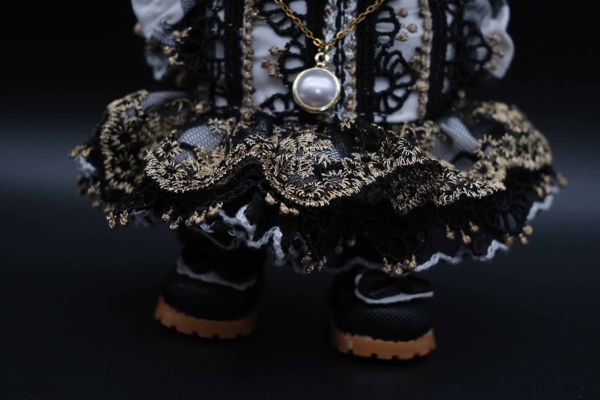 a close-up of labubu's french dress and black shoes