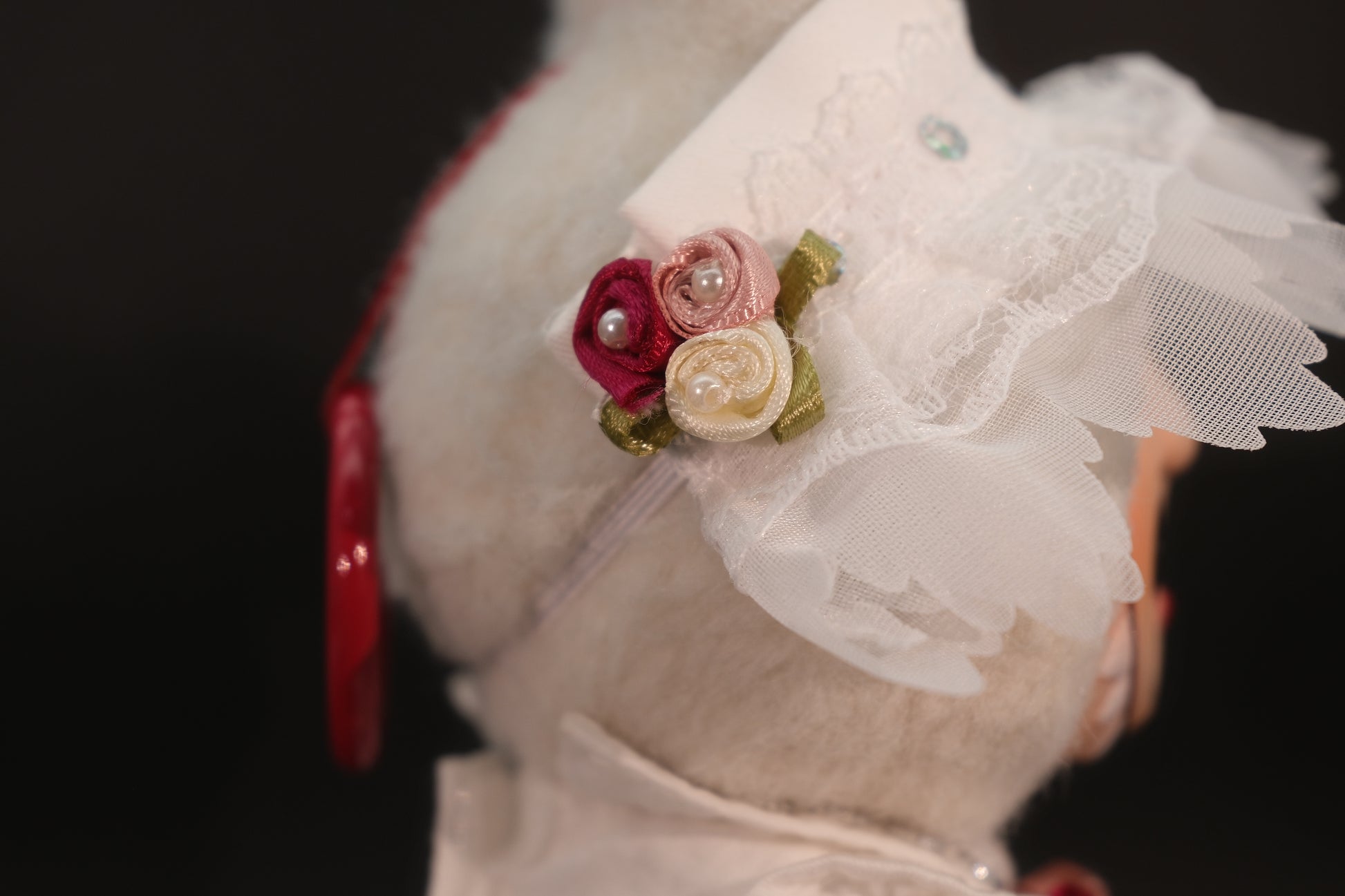 A close-up of full body shot of the Labubu figure wearing the complete white dressoutfit