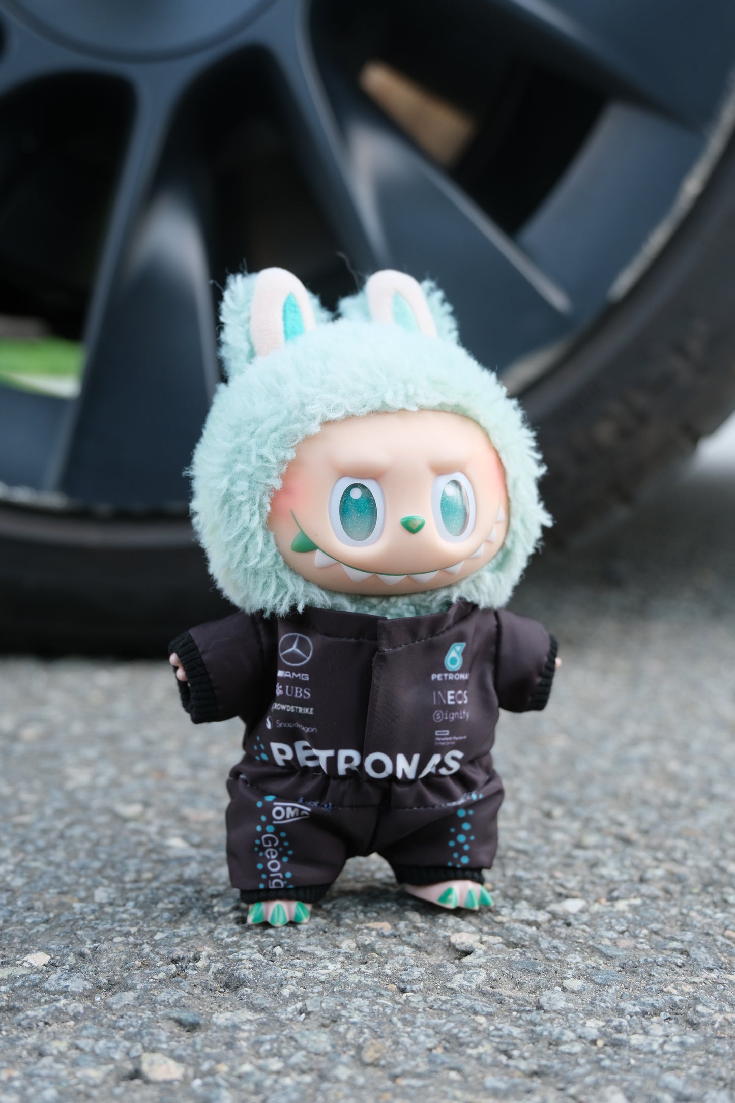 A collection of four LABUBU dolls wearing handmade F1 team uniforms from Mercedes