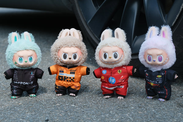 A collection of four LABUBU dolls wearing handmade F1 team uniforms from Mercedes, McLaren, Ferrari, and Red Bull Racing.